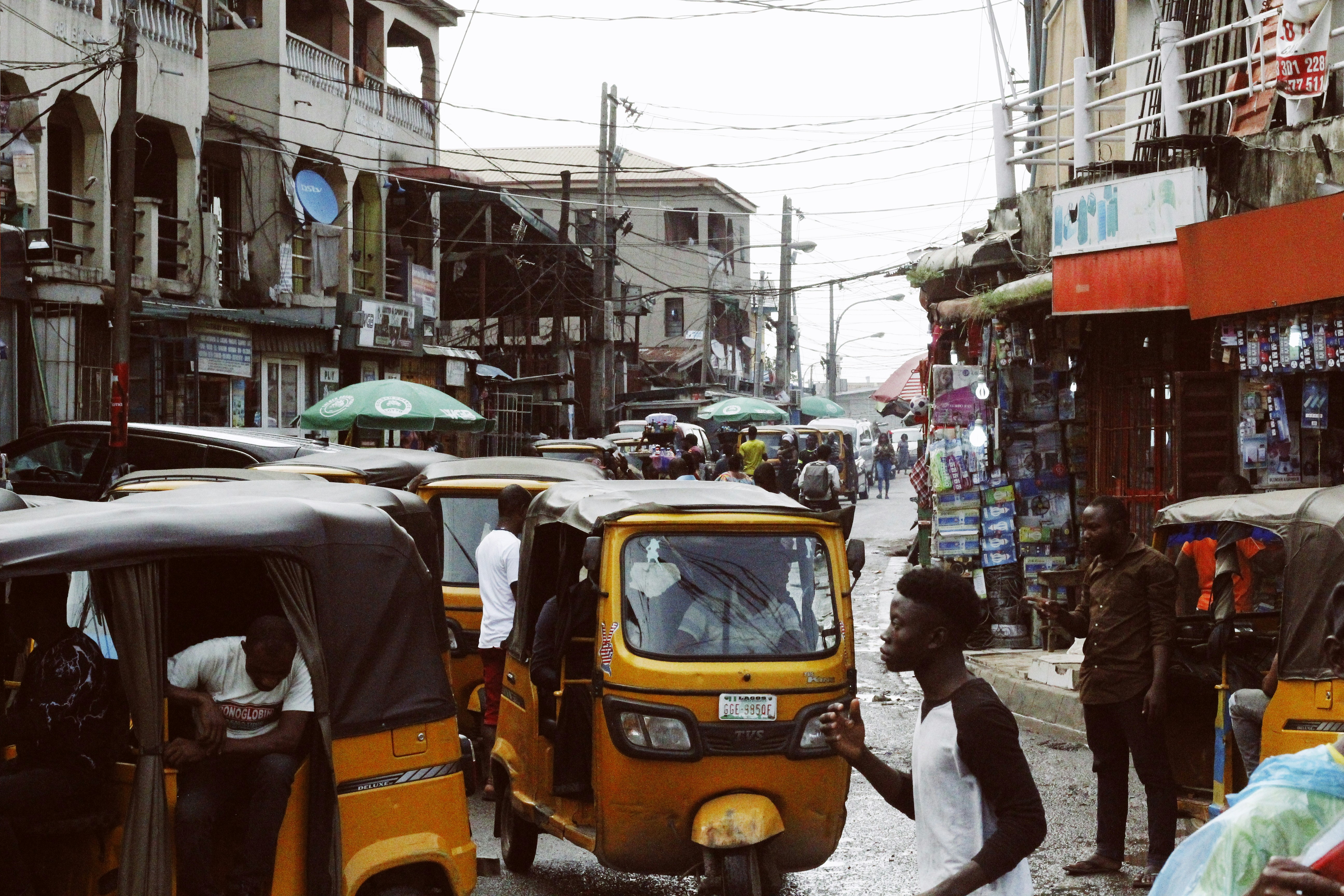 A busy Lagos street with people and homes